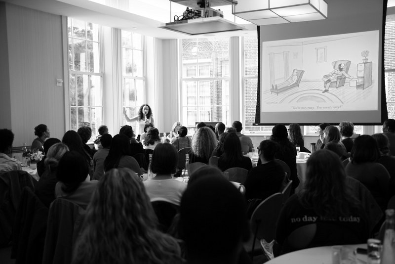 Large group of workshop attendees listening and watching presentation